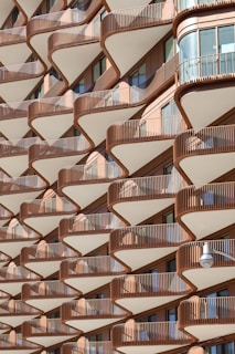 An apartment building has wavy, layered balconies.
