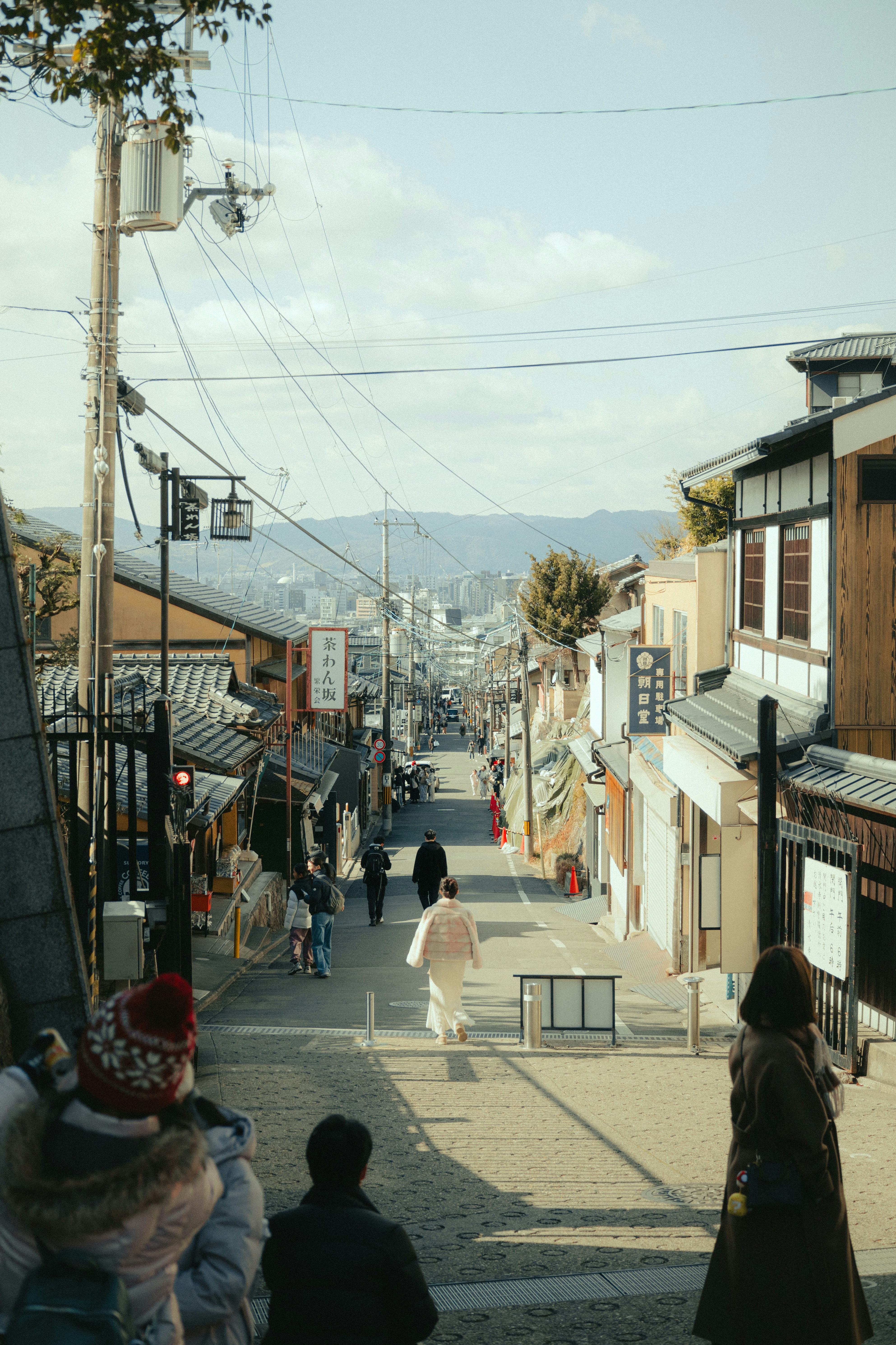A street descends through a traditional japanese town.