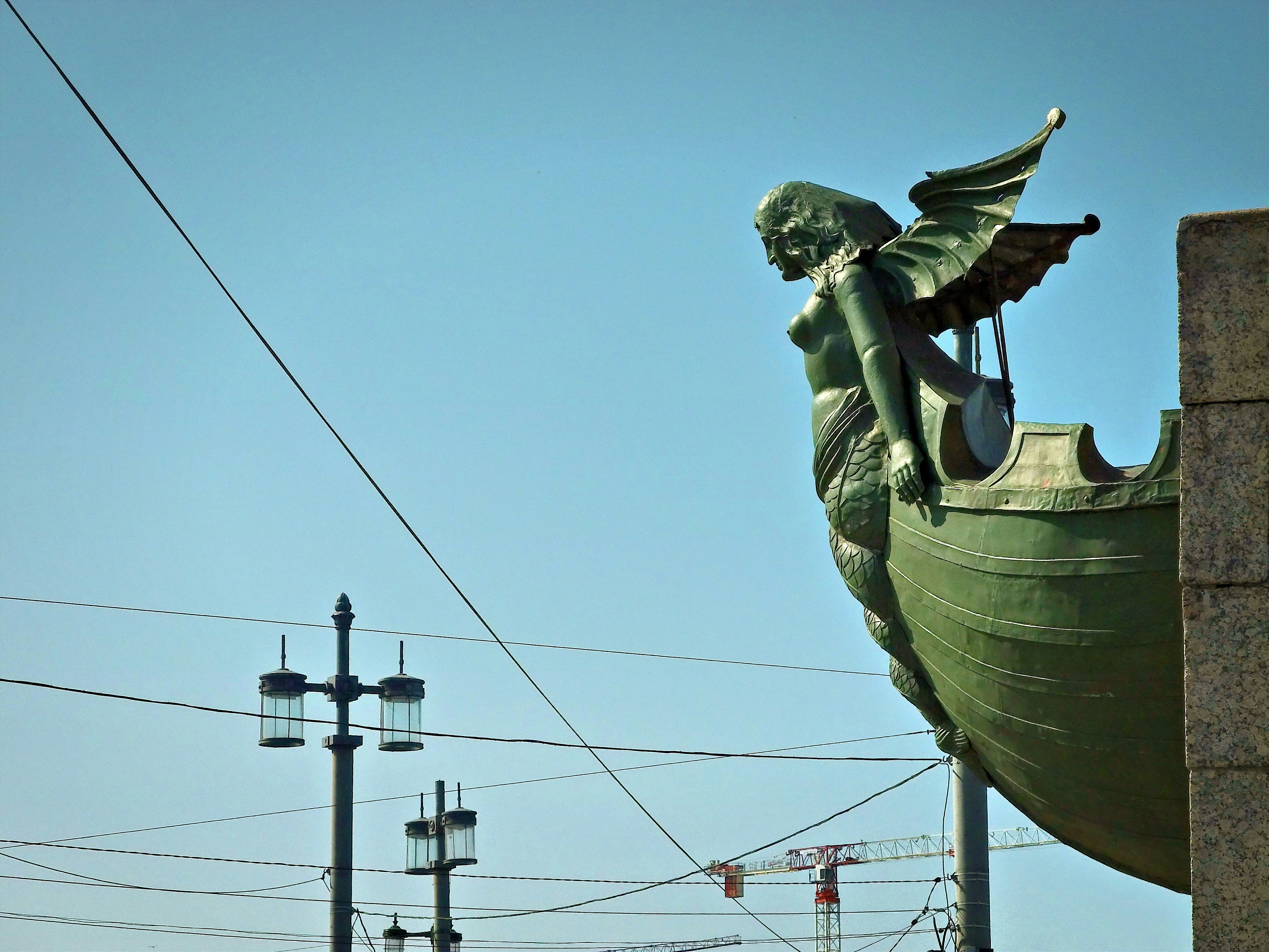 A statue of a winged woman on a boat.