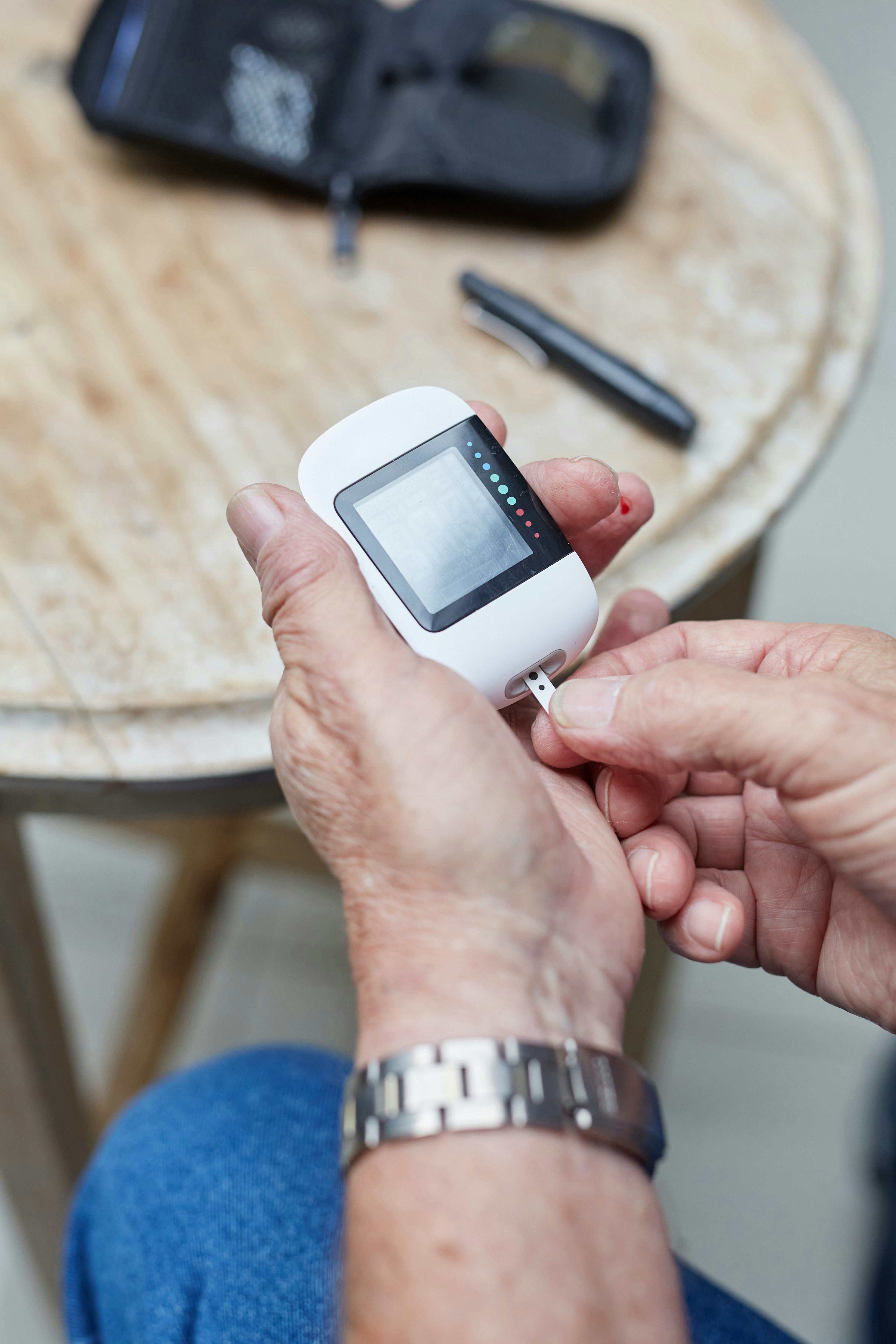Someone is checking their blood sugar with a meter.