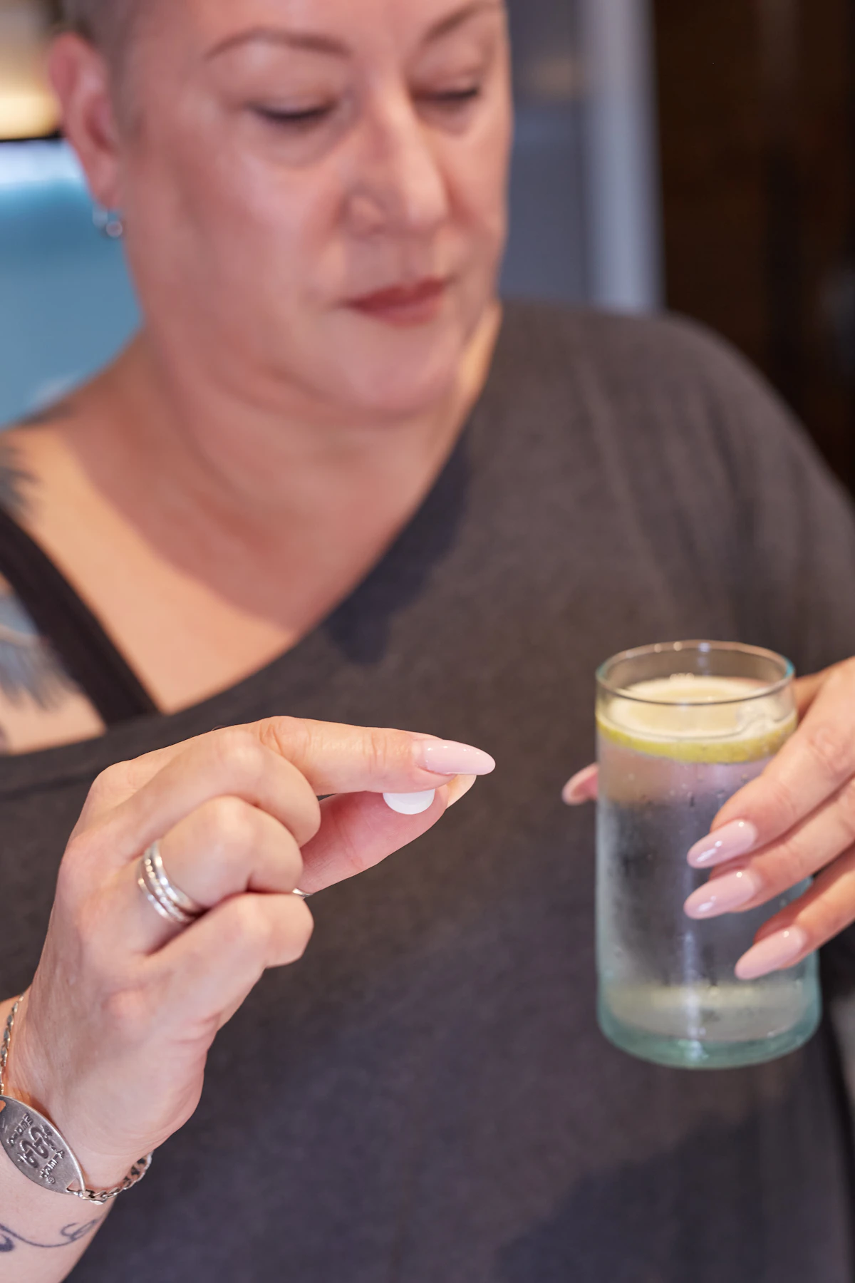 Woman about to take a daily supplement