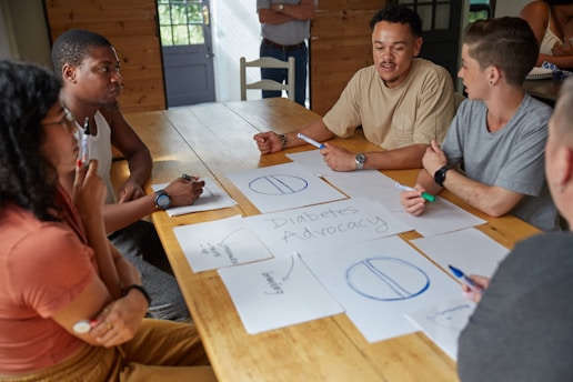 People collaborate on a project at a table.