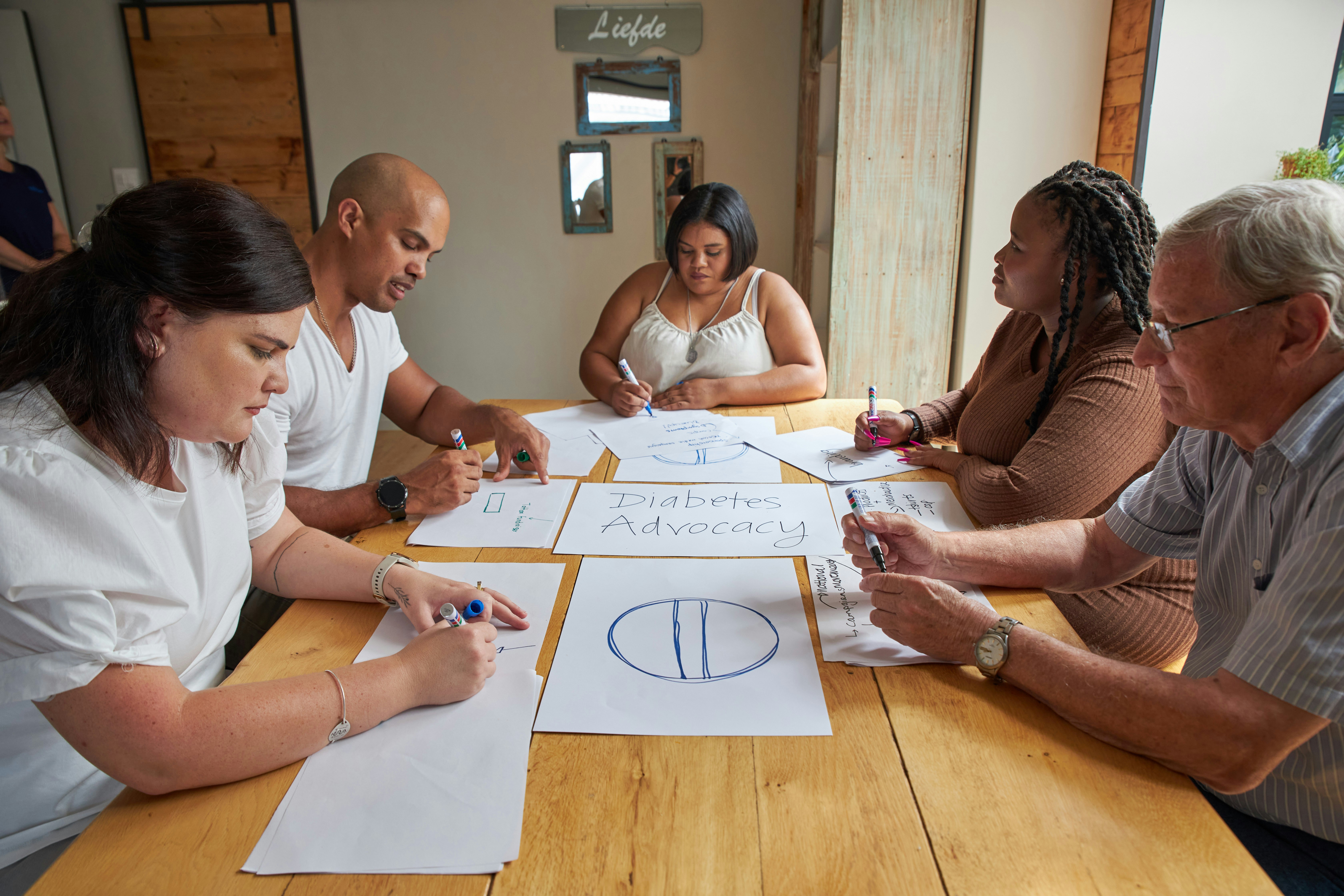 Diverse team collaborating around a table with documents