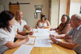A group of people are brainstorming and sketching together.