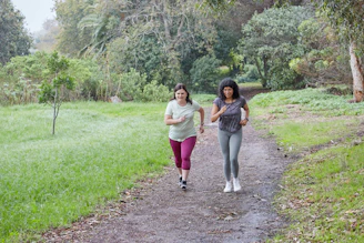Two women are running together on a path