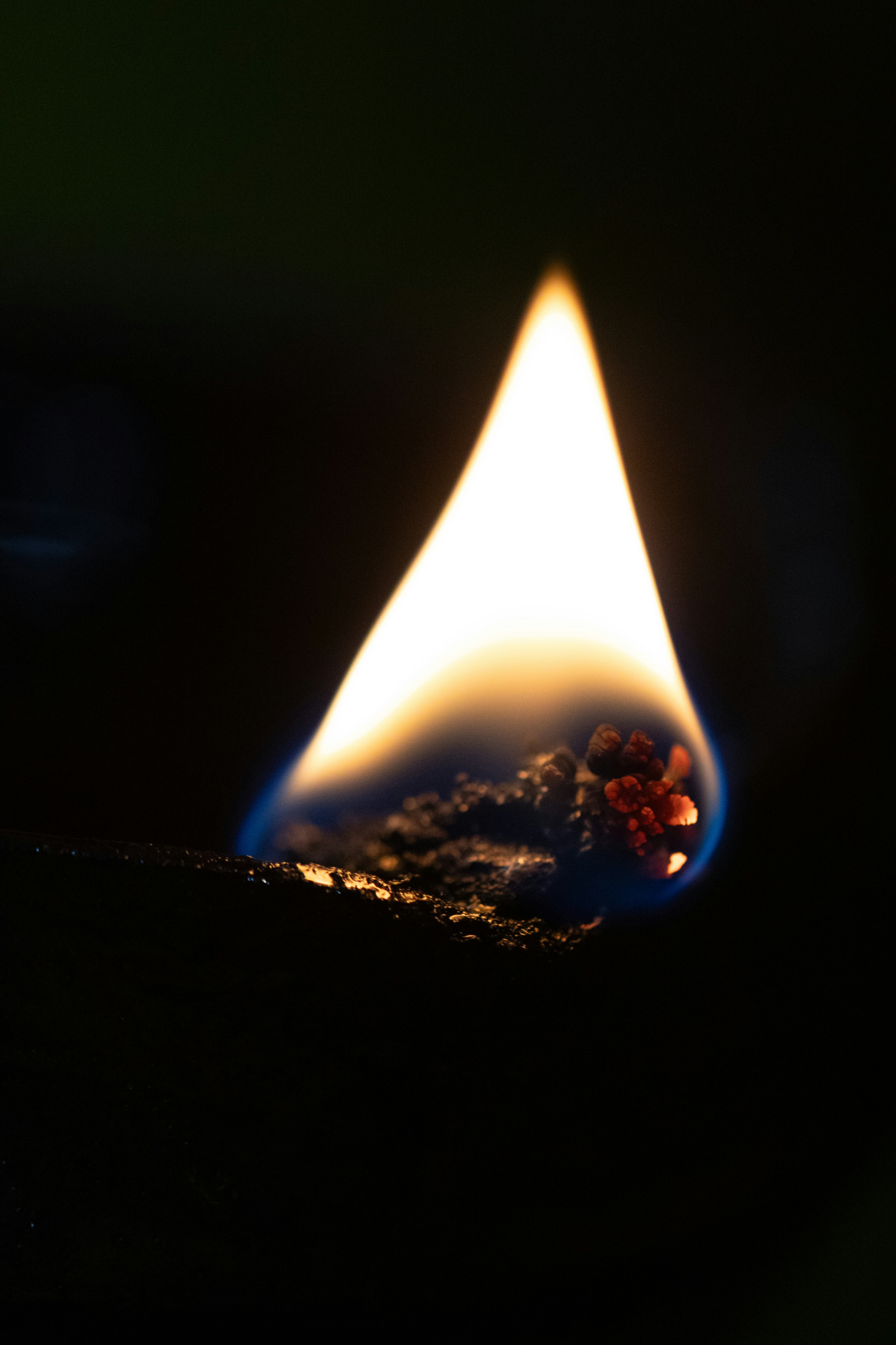 A match flickers brightly against a dark background.
