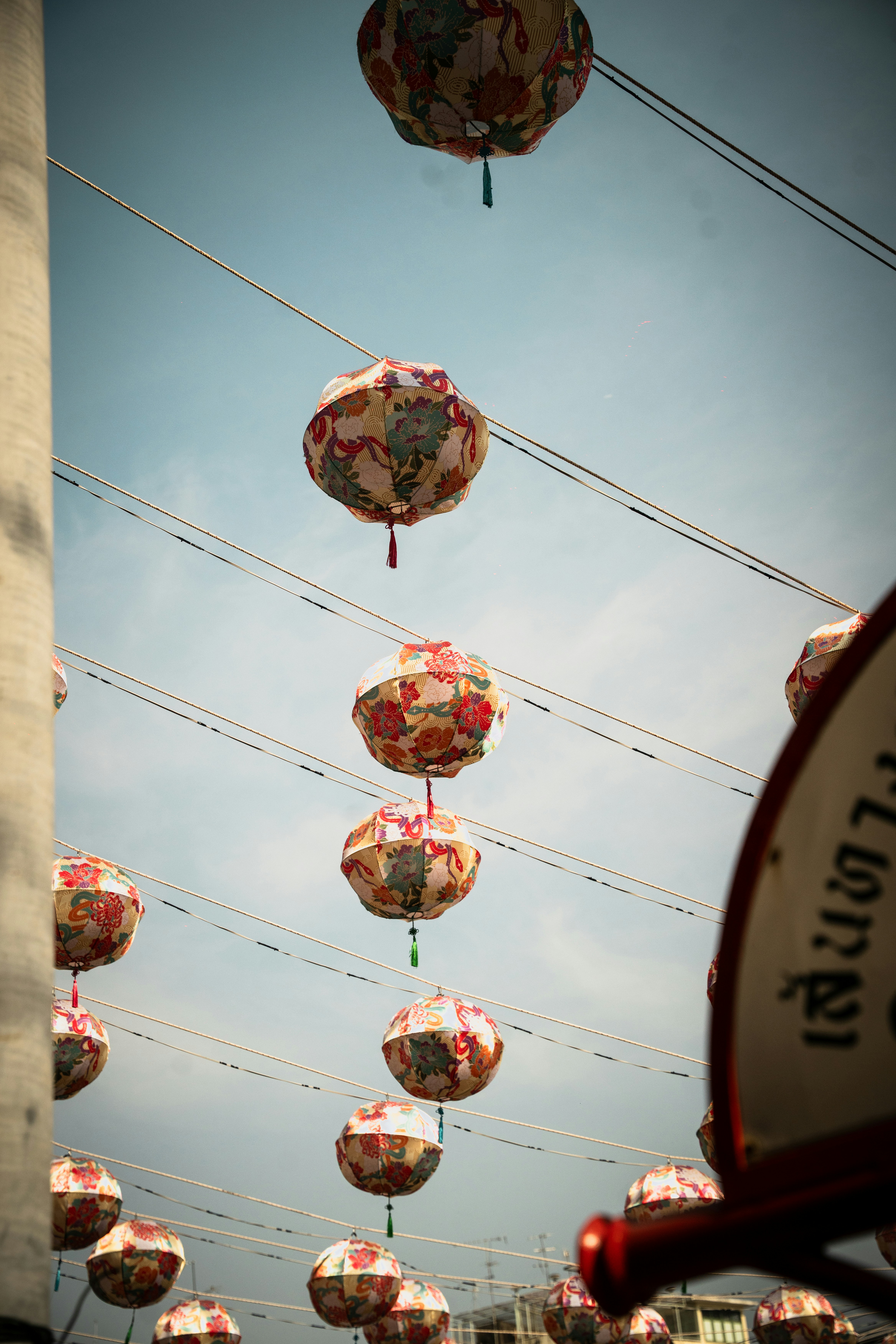 Lanterns hang in the sky, strung on wires.