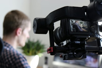 A man is filmed with a camera.