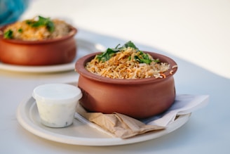 Delicious rice dish served in a clay bowl.