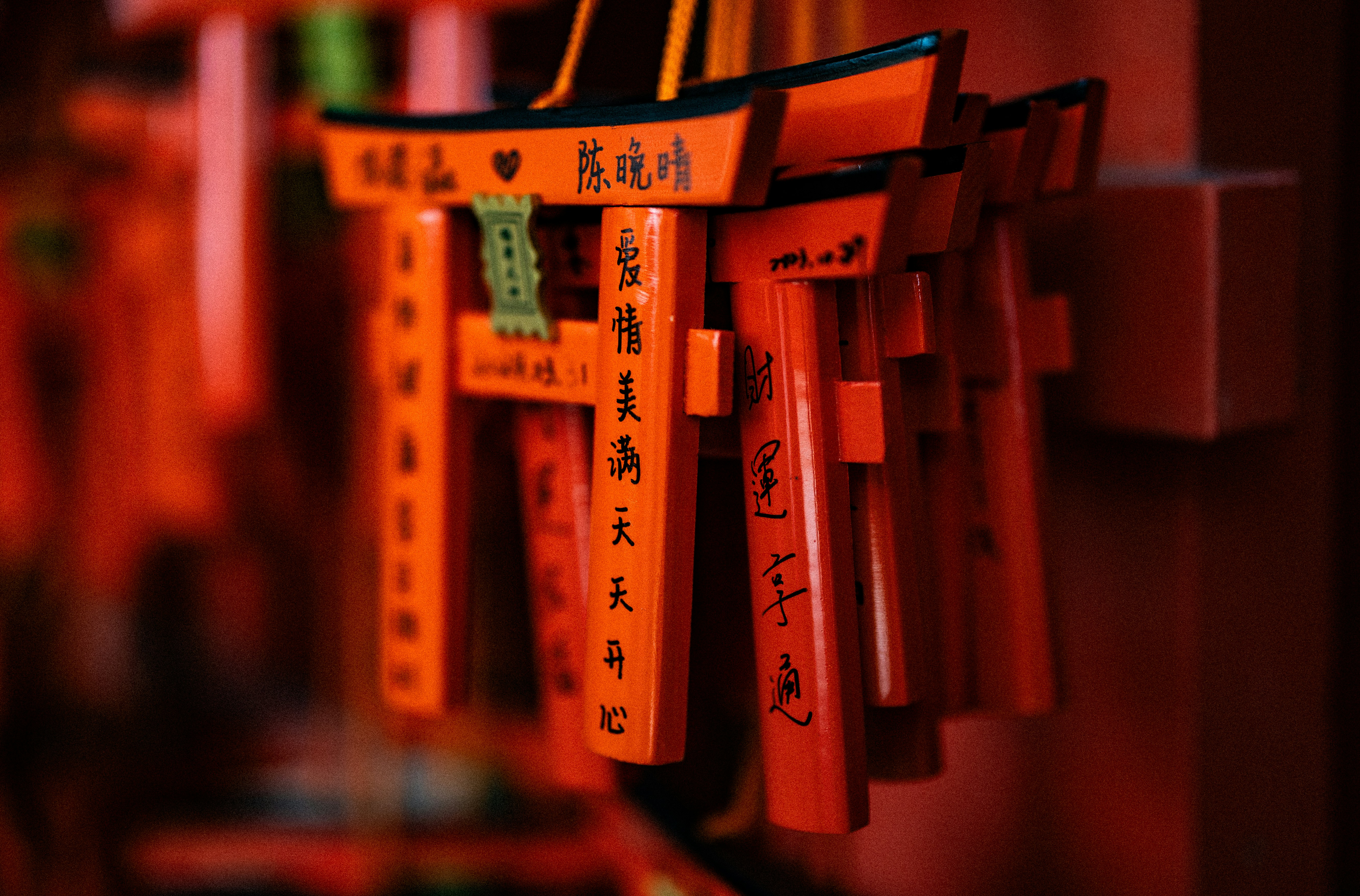 Miniature torii gates with japanese inscriptions are shown.