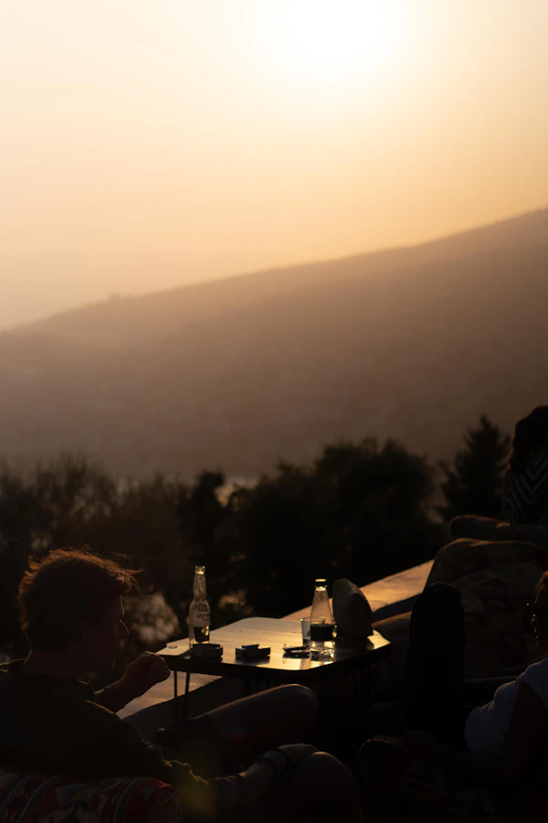 Friends at a table at sunset in the mountains