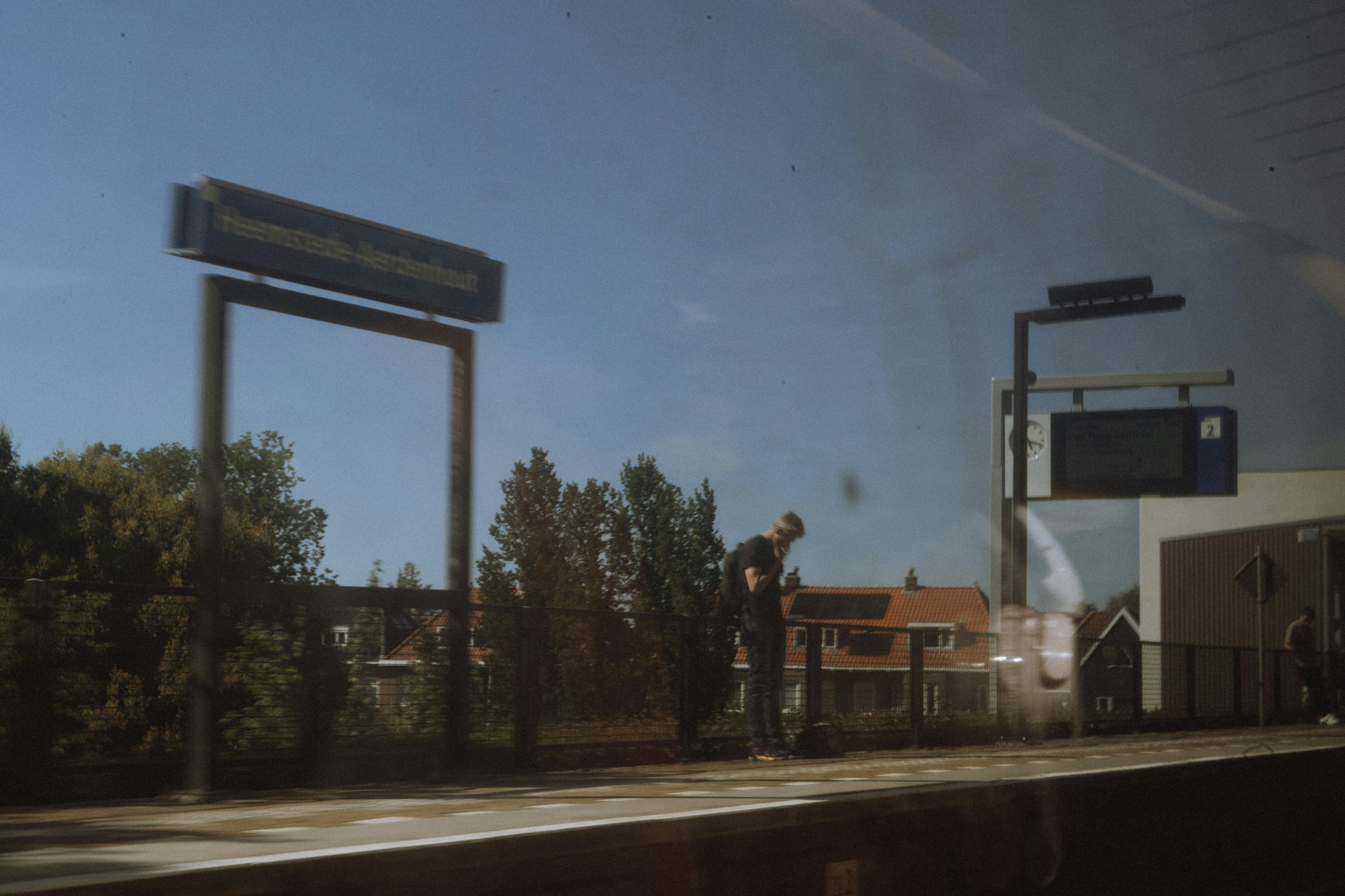 A person waits at the train station.
