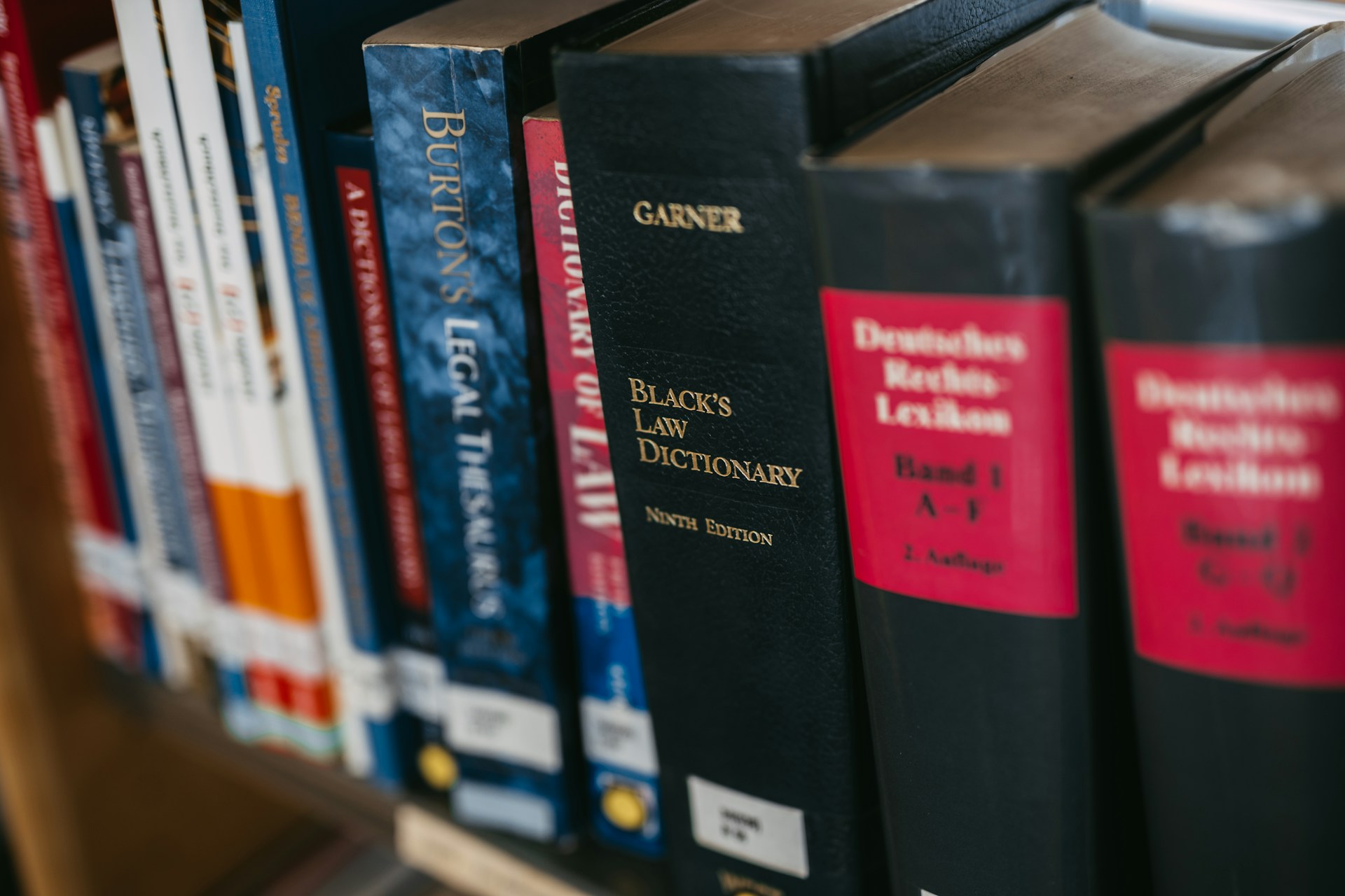 Law books are lined up on a shelf.