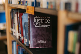 A book about administrative justice is on a shelf.