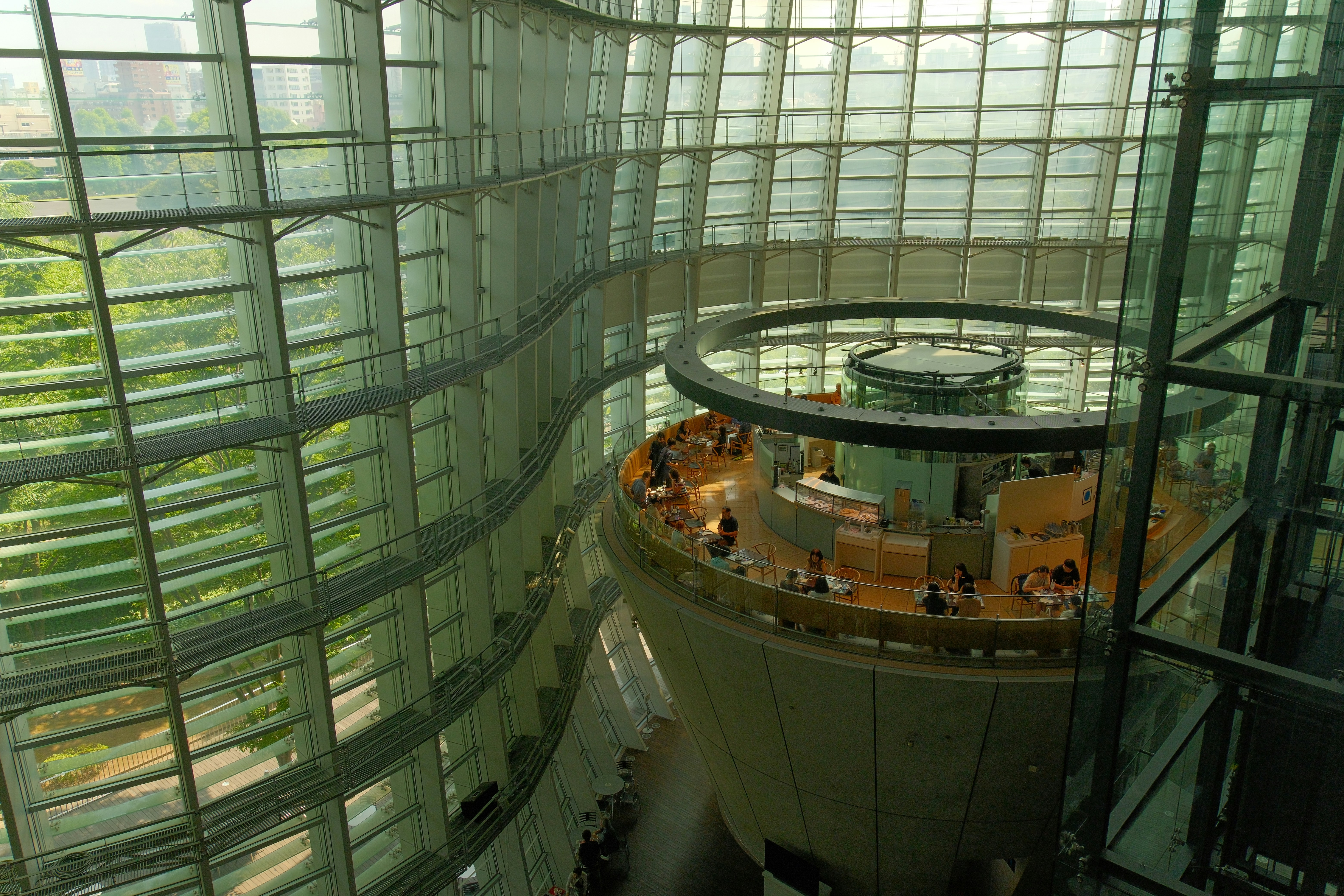A modern building with glass walls and a central tower.