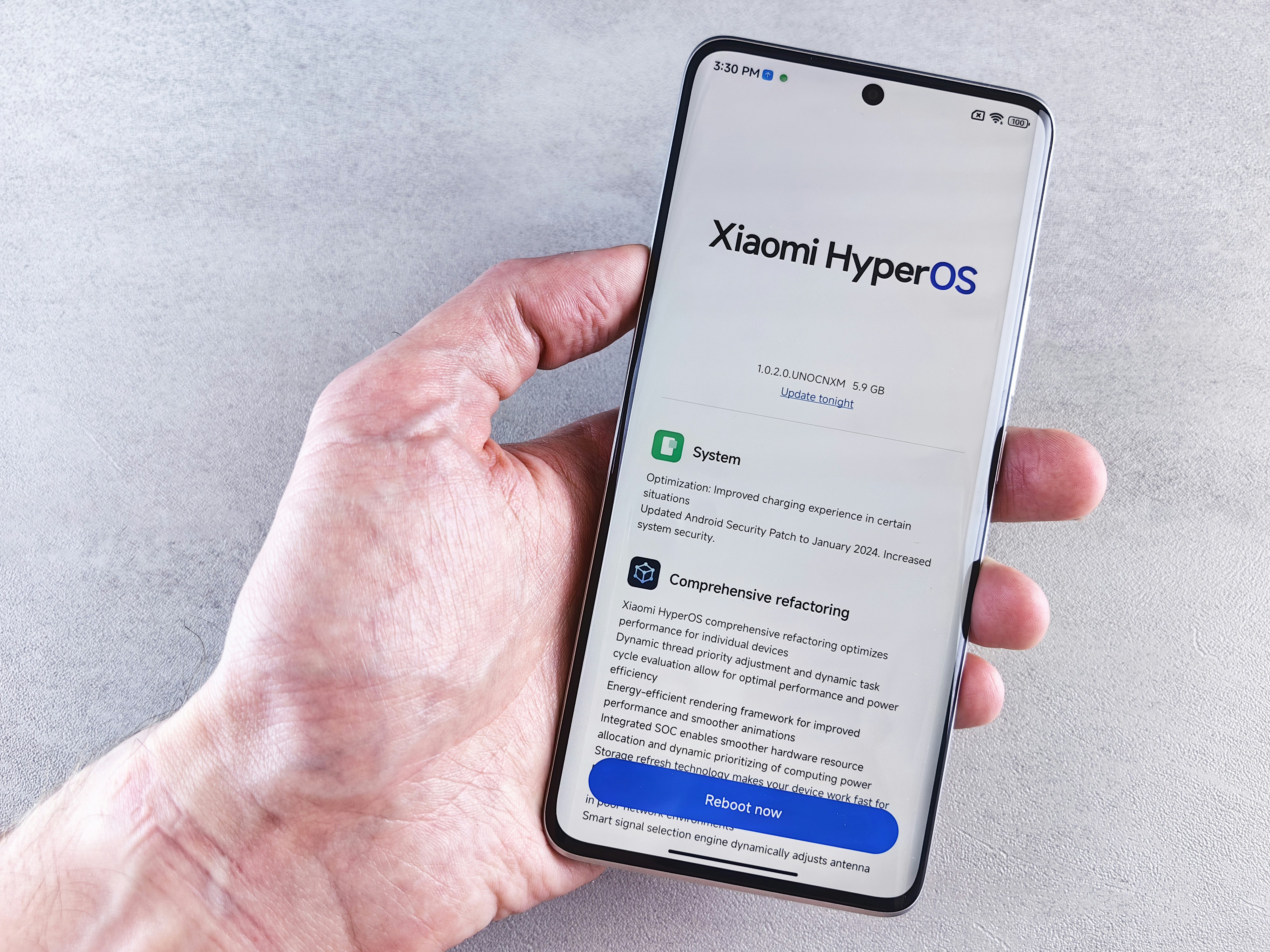 A hand is holding a phone with xiaomi hyperos