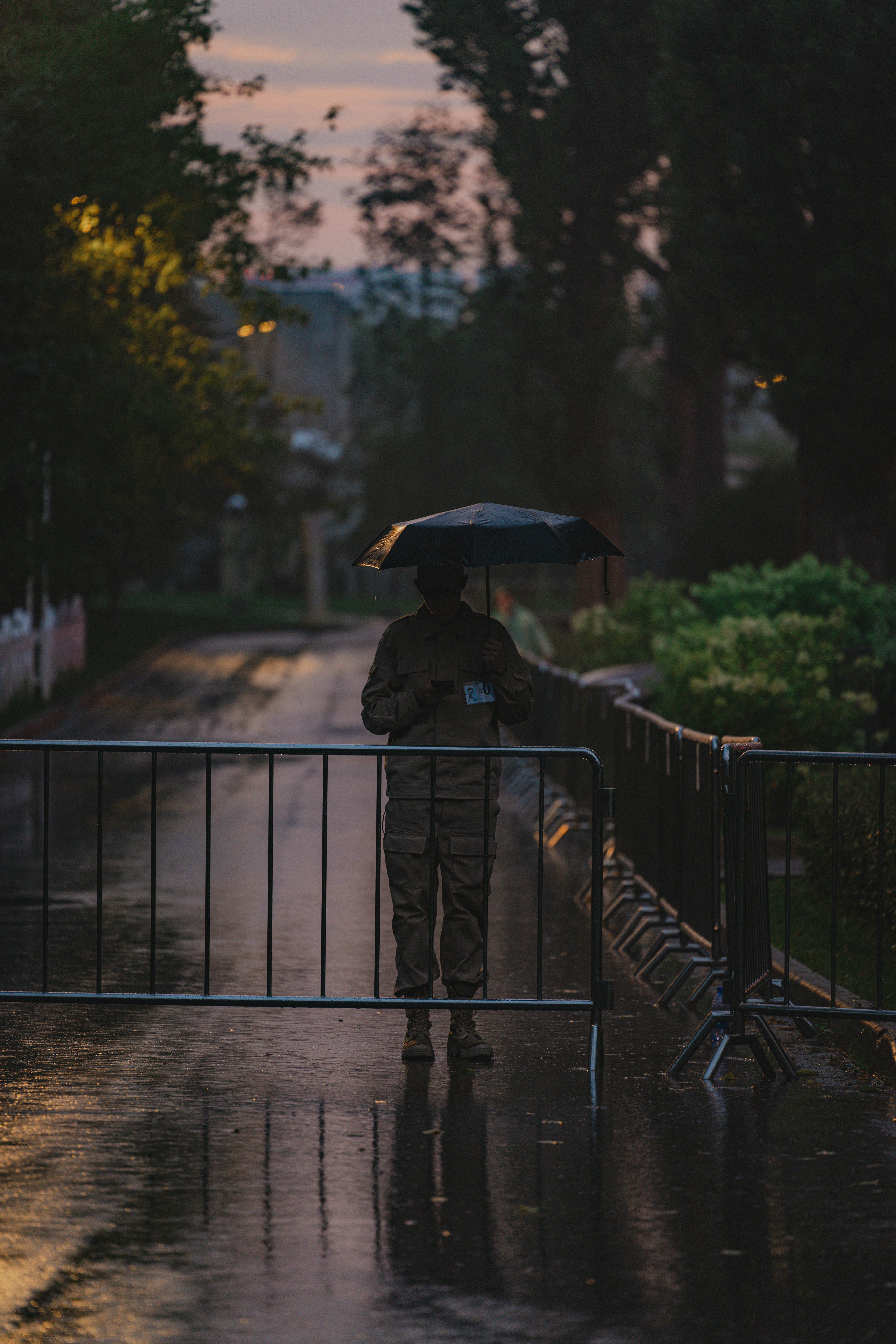 A soldier stands guard in the rain.