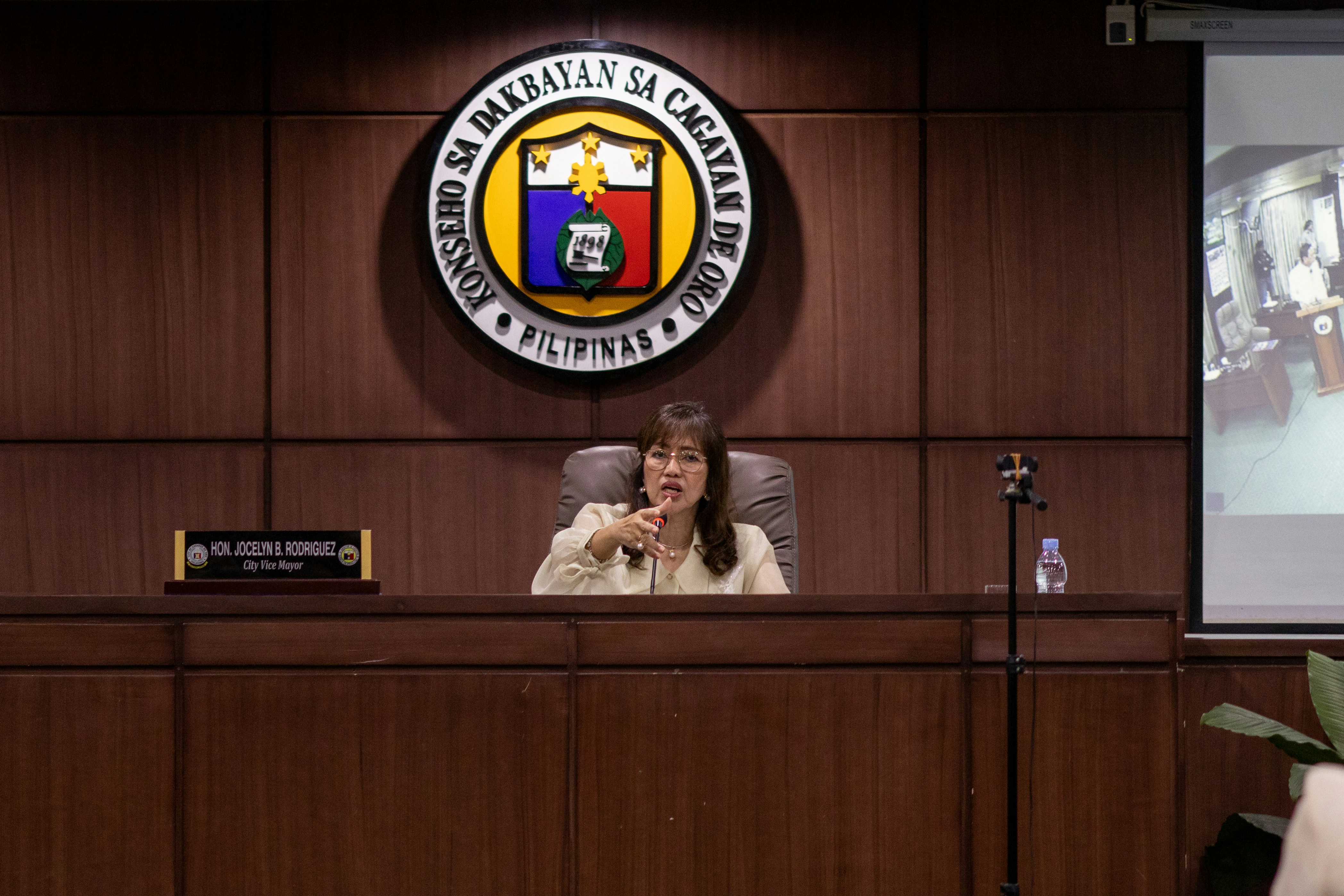 A woman speaks at a podium in an office.