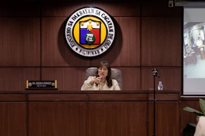A woman speaks at a podium in an office.