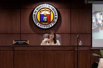 A woman speaks at a podium in an office.