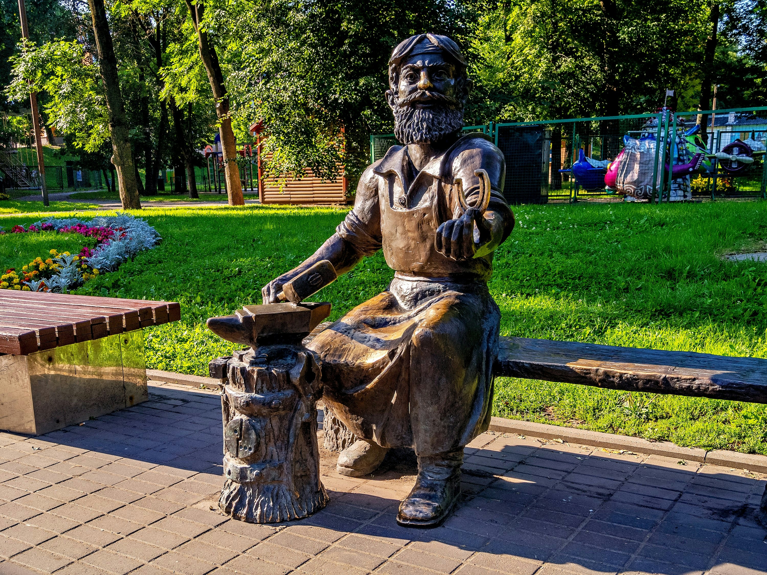 A bronze statue of a blacksmith.