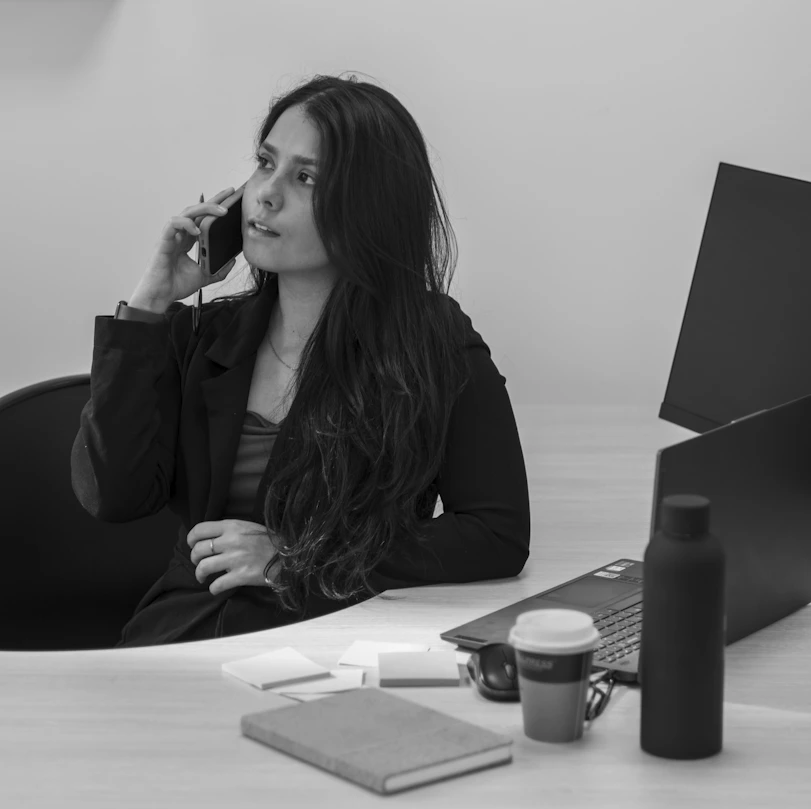 Businesswoman talks on the phone while working.