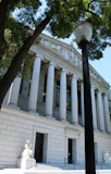 A classical building with columns and a lamppost.