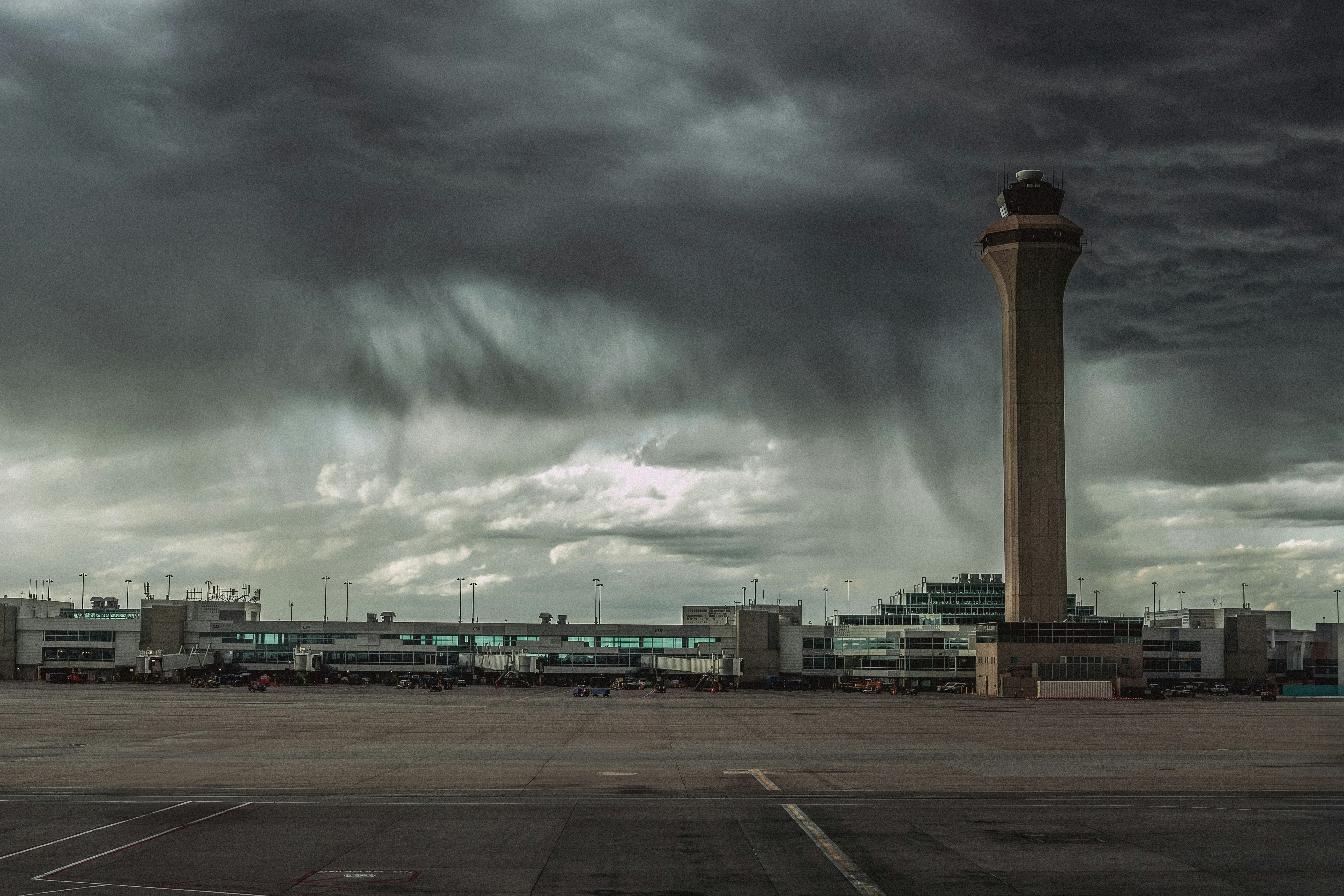 A storm approaches an airport tower., Rain Delay