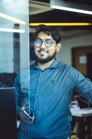 A smiling man looks happily at the camera.