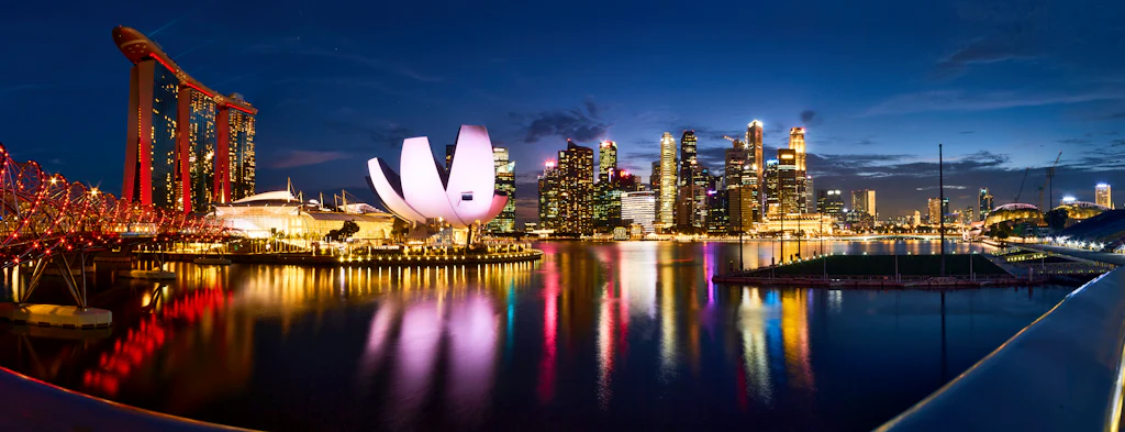 Marina Bay at blue hour with the skyline and ArtScience Museum reflected in still water