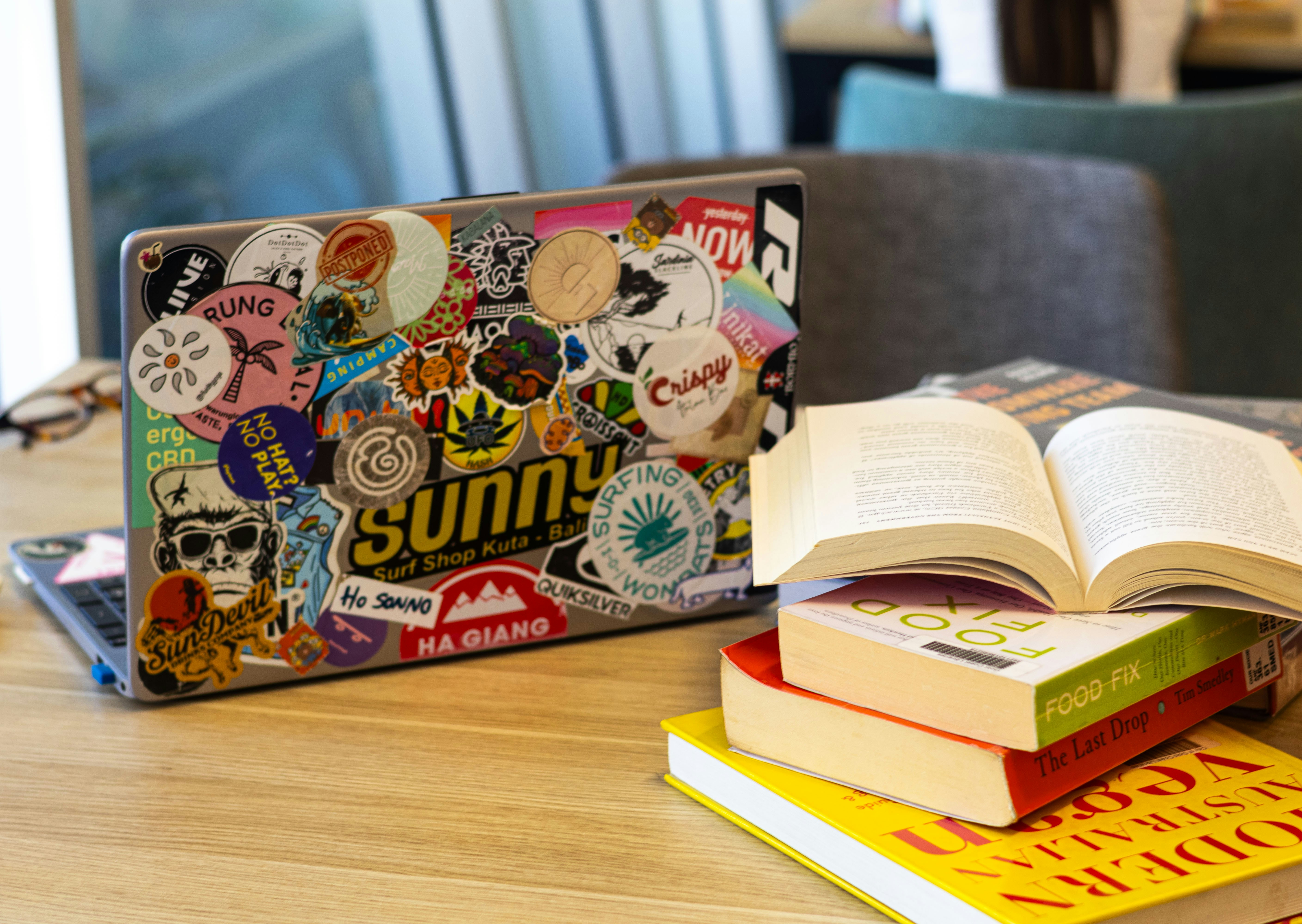 Laptop and books on wooden table