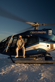 A person sits in a helicopter.