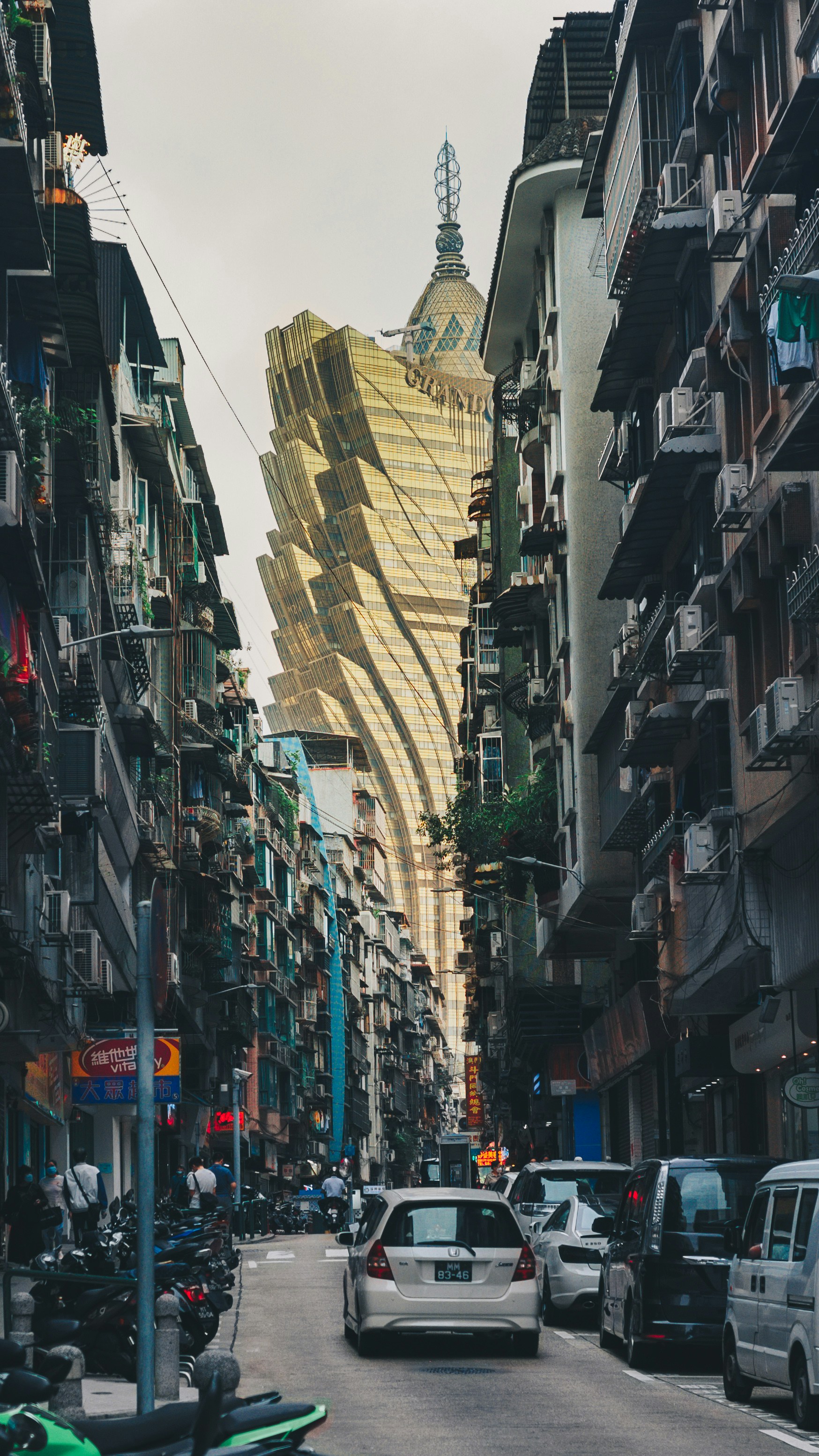 A tall building dominates the street view.