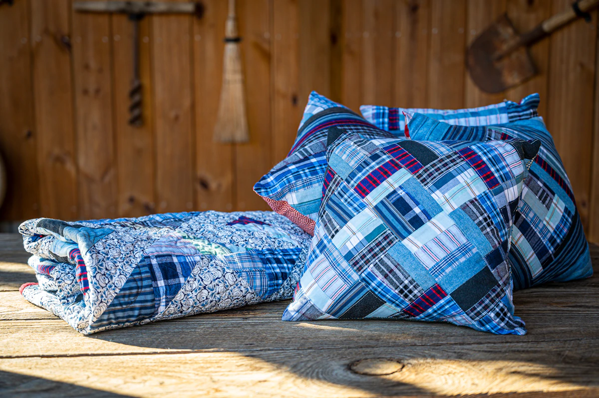 Patchwork quilt and coordinating pillow covers displayed together