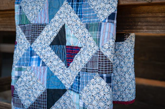 A quilt with geometric shapes is visible.