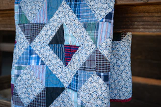A quilt with geometric shapes is visible.