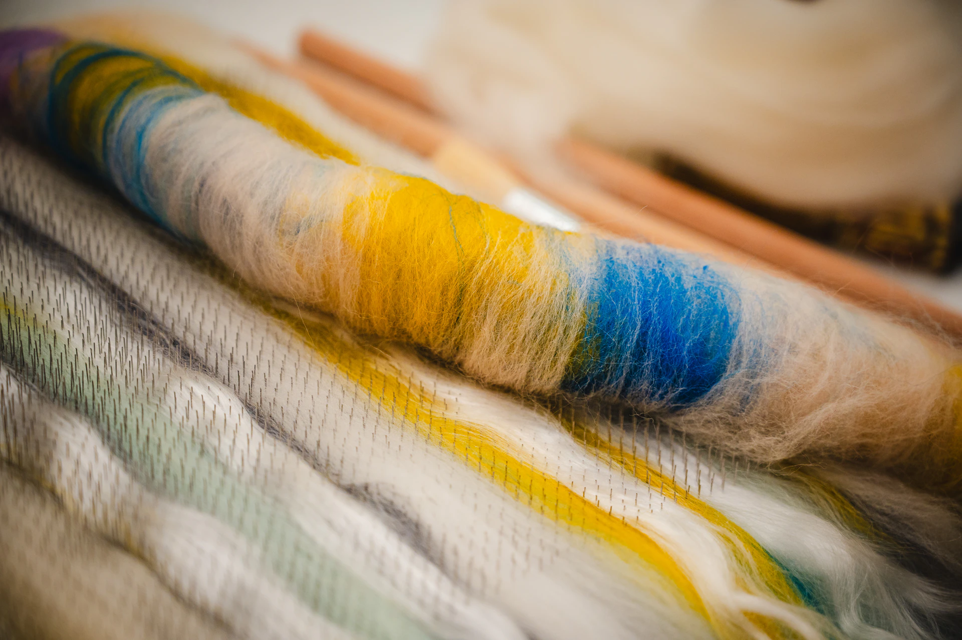 Colorful yarn and knitting needles are artfully arranged.