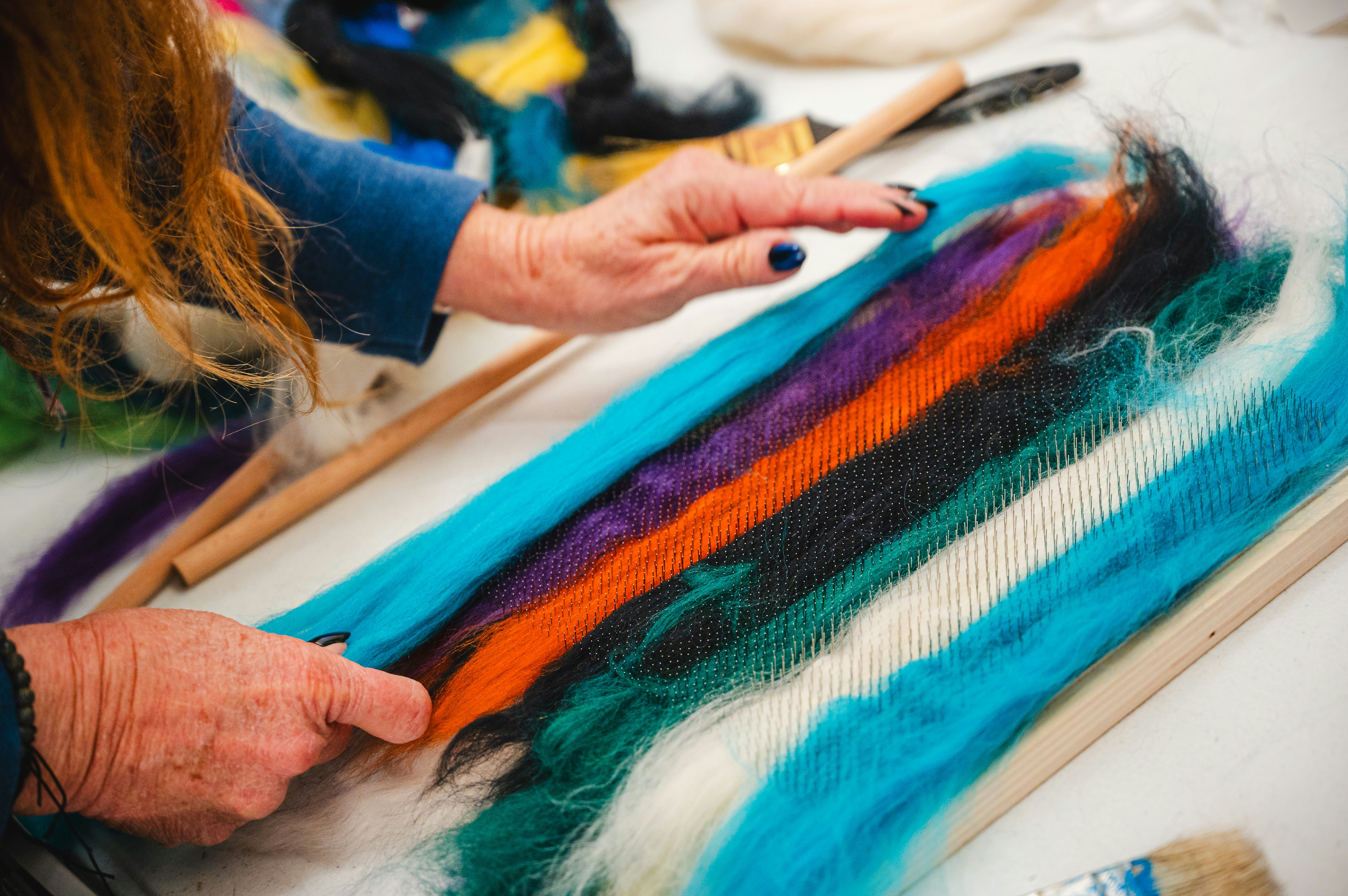 Handmaking yarn by blending different colors.