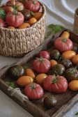 Fresh, colorful tomatoes displayed on a wooden tray.