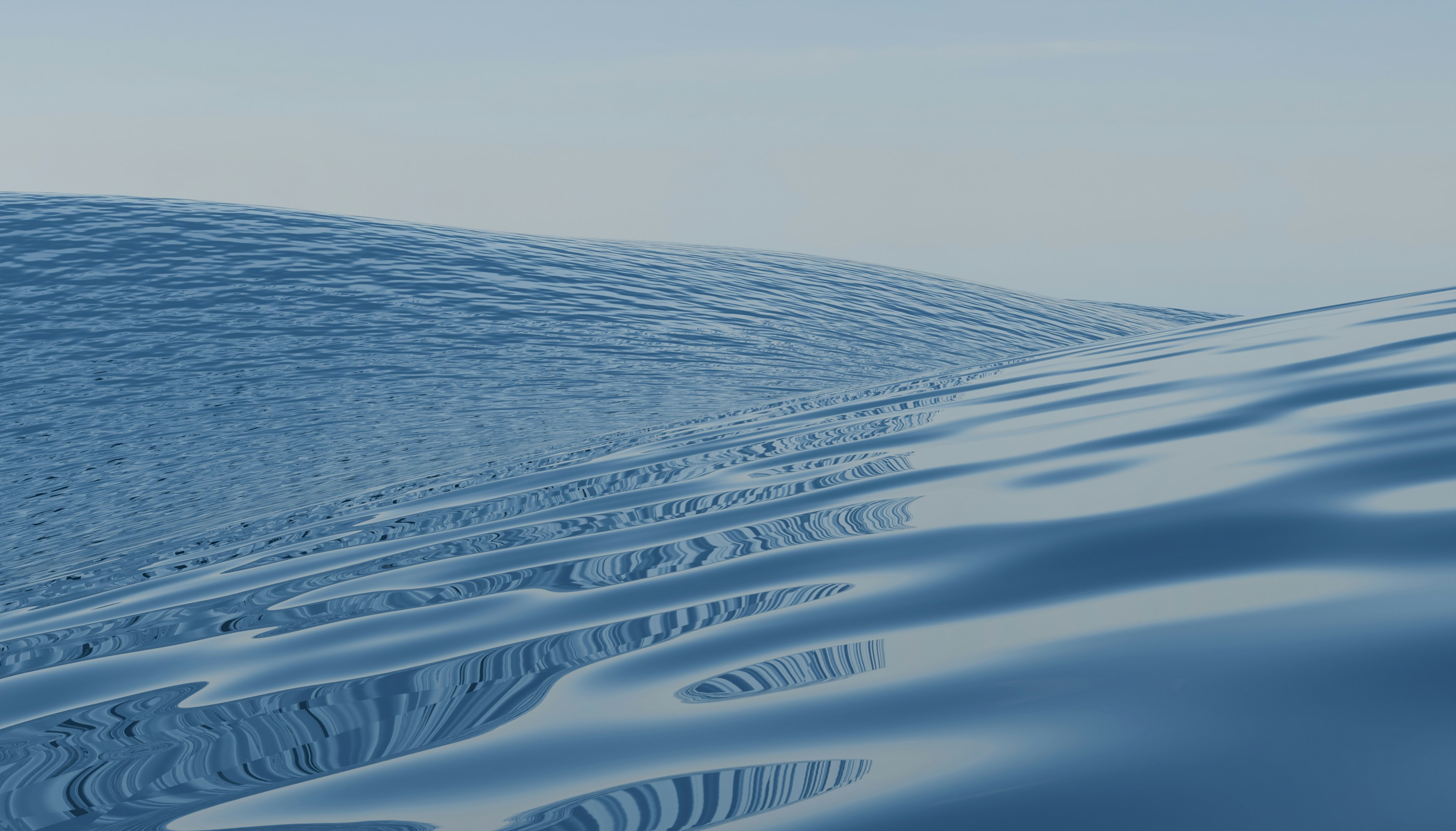 Calm, rippling blue water stretches to the horizon.