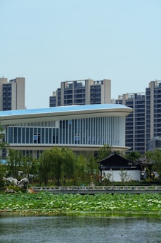 Modern buildings and a tranquil lake scene.