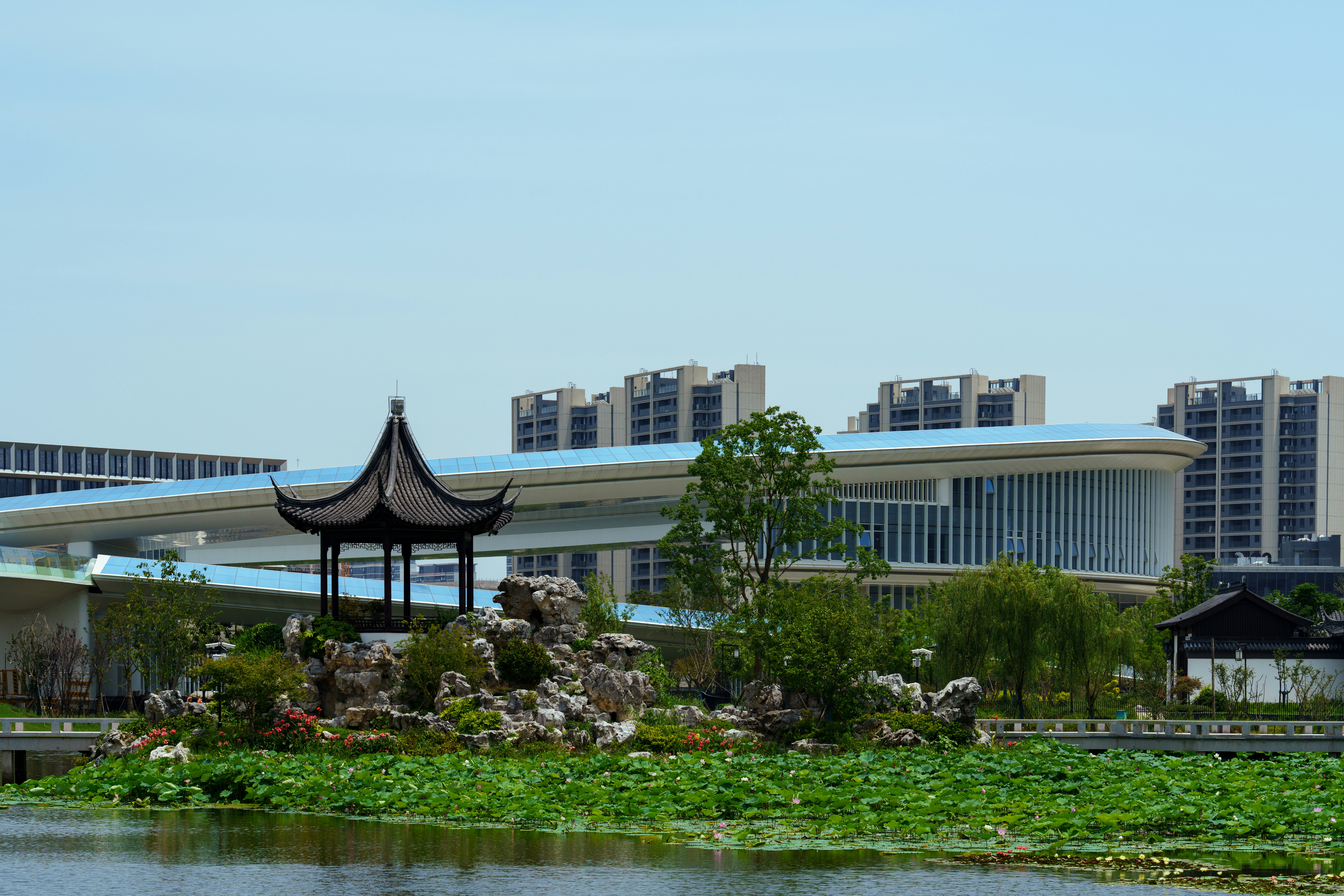 A chinese pagoda sits in front of a lake.
