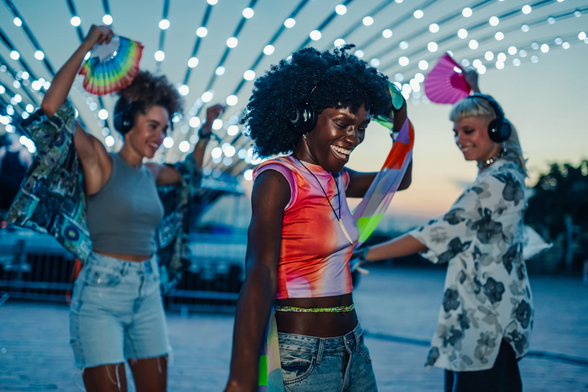 Friends dancing with headphones at a silent disco