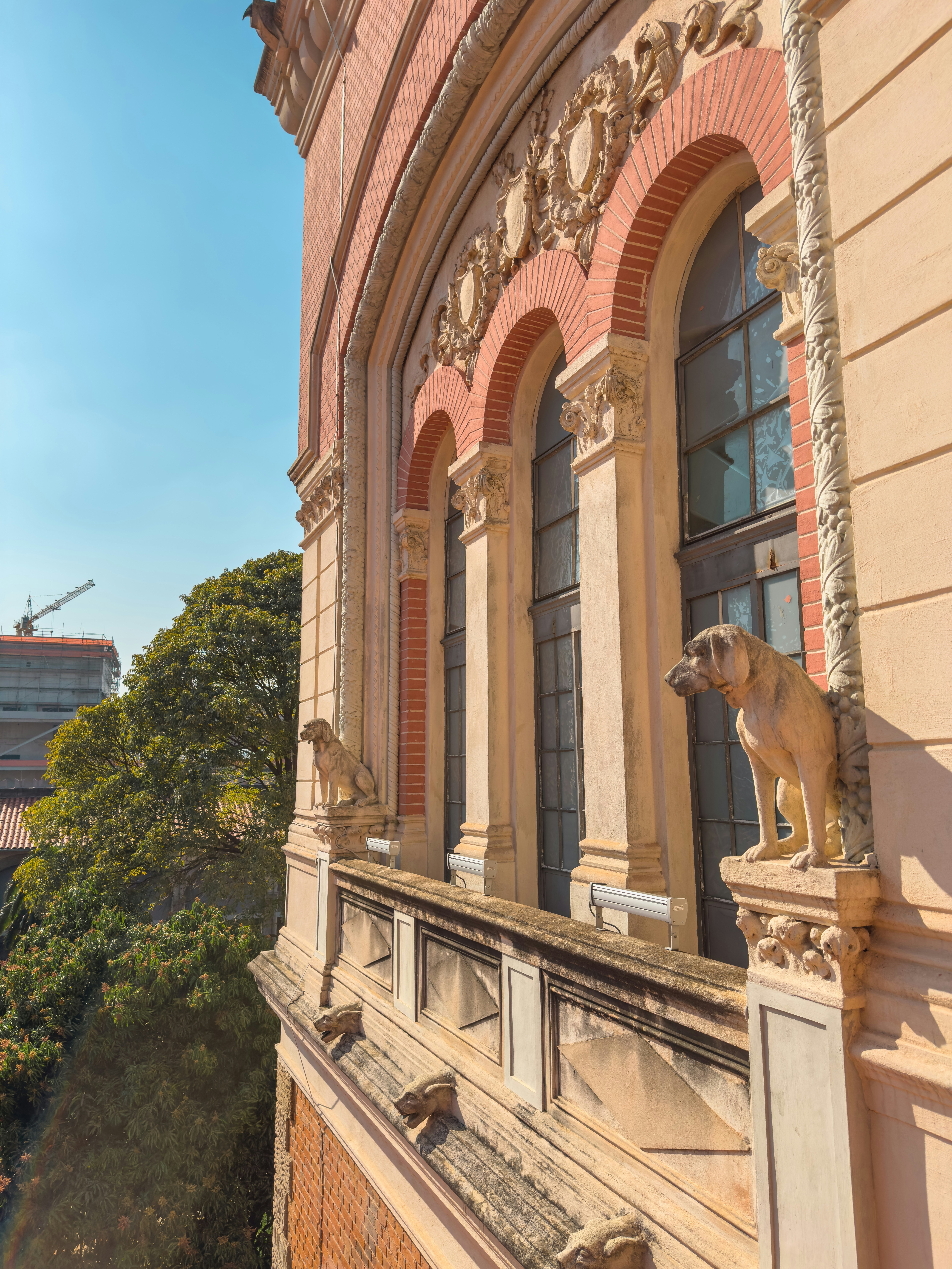 Architectural detail with stone sculptures and windows.