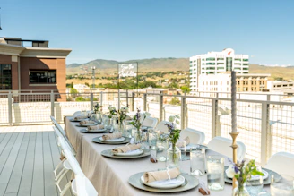 A rooftop dining table set for an elegant event.