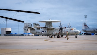 A military airplane sits on an airfield.