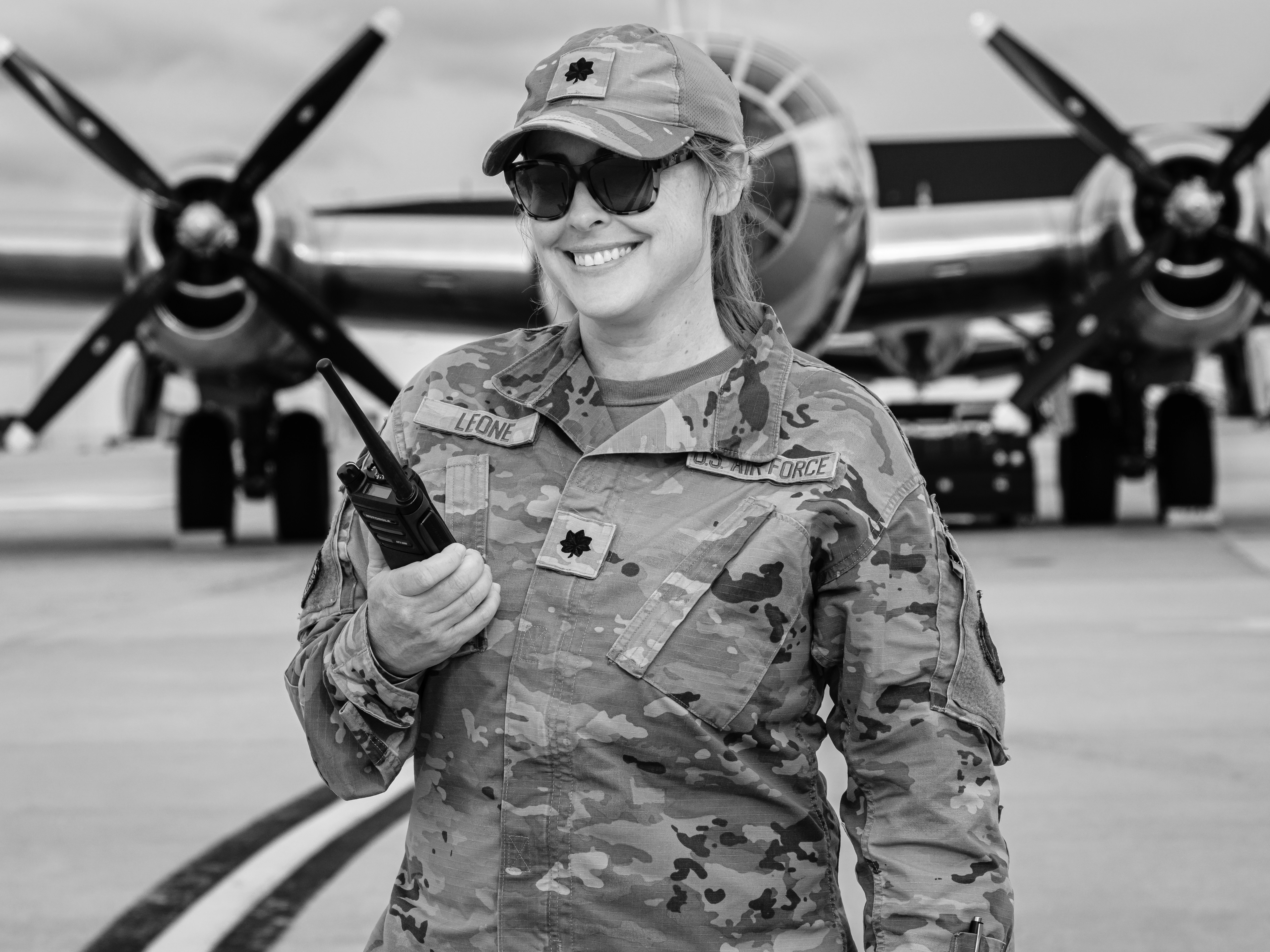 Smiling soldier poses near a plane.