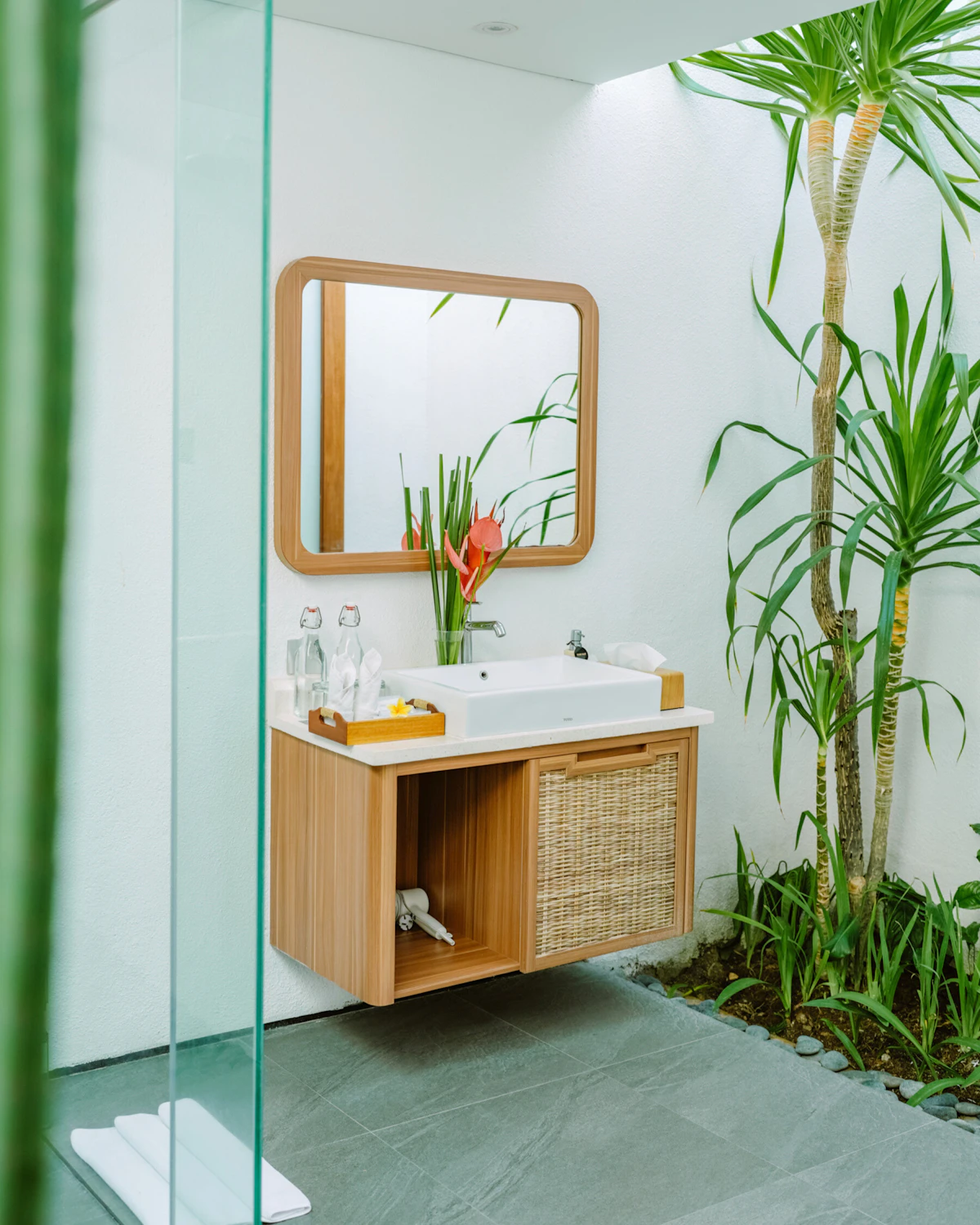 Bright, naturally lit bathroom with tropical greenery