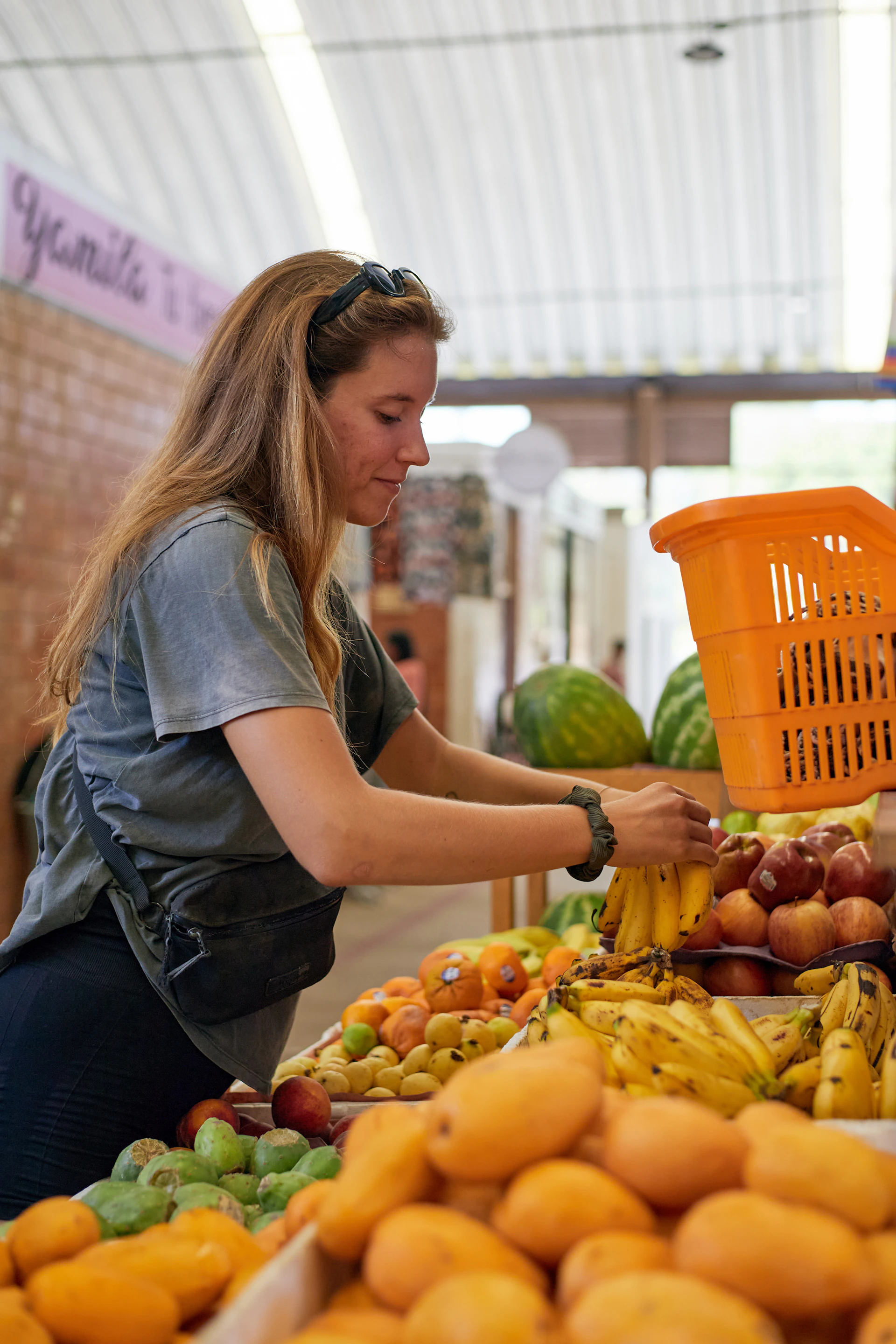 Woman shops for fresh fruits at a market
