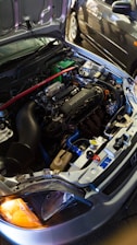 A modified honda engine under the hood.